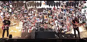 Blink-182 performing at Coachella 2023 From left to right: Mark Hoppus, Travis Barker, and Tom DeLonge.