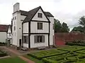 The hunting lodge, framed by its own chimney stack and stairway.