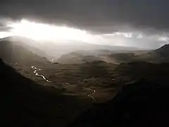Looking south-west from just under Bow Fell summit towards Eskdale under darkening skies