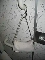 Spring closing bracelet type of purse hook.