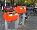 A Dutch "Post-NL" postbox in orange at different heights