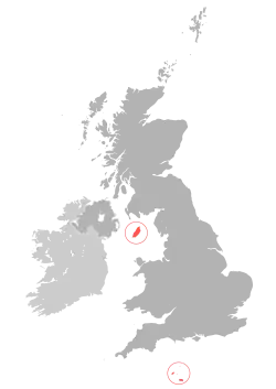 Location of the Crown Dependencies (red) relative to the United Kingdom (dark grey) and Ireland (light grey)