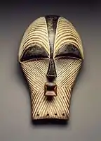 Female kifwebe mask; late 19th or early 20th century; 30.5 x 18.1 x 15.6&nbsp;cm (12 x 7.mw-parser-output .frac{white-space:nowrap}.mw-parser-output .frac .num,.mw-parser-output .frac .den{font-size:80%;line-height:0;vertical-align:super}.mw-parser-output .frac .den{vertical-align:sub}.mw-parser-output .sr-only{border:0;clip:rect(0,0,0,0);clip-path:polygon(0px 0px,0px 0px,0px 0px);height:1px;margin:-1px;overflow:hidden;padding:0;position:absolute;width:1px}1⁄8 x 6.mw-parser-output .frac{white-space:nowrap}.mw-parser-output .frac .num,.mw-parser-output .frac .den{font-size:80%;line-height:0;vertical-align:super}.mw-parser-output .frac .den{vertical-align:sub}.mw-parser-output .sr-only{border:0;clip:rect(0,0,0,0);clip-path:polygon(0px 0px,0px 0px,0px 0px);height:1px;margin:-1px;overflow:hidden;padding:0;position:absolute;width:1px}1⁄8 in.); Brooklyn Museum. The kifwebe masquerade is a genre shared by the Luba and Songye, indicative of the interaction that has occurred between the two societies. Kifwebe masks represent either male or female beings