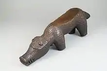 Itoon (diviner's instrument, in form of a hippopotamus); 19th century; wood; 7.5 × 26.6 × 6.4&nbsp;cm (2.mw-parser-output .frac{white-space:nowrap}.mw-parser-output .frac .num,.mw-parser-output .frac .den{font-size:80%;line-height:0;vertical-align:super}.mw-parser-output .frac .den{vertical-align:sub}.mw-parser-output .sr-only{border:0;clip:rect(0,0,0,0);clip-path:polygon(0px 0px,0px 0px,0px 0px);height:1px;margin:-1px;overflow:hidden;padding:0;position:absolute;width:1px}15⁄16 × 10.mw-parser-output .frac{white-space:nowrap}.mw-parser-output .frac .num,.mw-parser-output .frac .den{font-size:80%;line-height:0;vertical-align:super}.mw-parser-output .frac .den{vertical-align:sub}.mw-parser-output .sr-only{border:0;clip:rect(0,0,0,0);clip-path:polygon(0px 0px,0px 0px,0px 0px);height:1px;margin:-1px;overflow:hidden;padding:0;position:absolute;width:1px}1⁄2 × 2.mw-parser-output .frac{white-space:nowrap}.mw-parser-output .frac .num,.mw-parser-output .frac .den{font-size:80%;line-height:0;vertical-align:super}.mw-parser-output .frac .den{vertical-align:sub}.mw-parser-output .sr-only{border:0;clip:rect(0,0,0,0);clip-path:polygon(0px 0px,0px 0px,0px 0px);height:1px;margin:-1px;overflow:hidden;padding:0;position:absolute;width:1px}1⁄2 in.); Brooklyn Museum