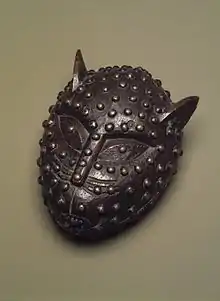 Box in the form of a leopard's head; 19th century; 17.1 x 14&nbsp;cm (6.mw-parser-output .frac{white-space:nowrap}.mw-parser-output .frac .num,.mw-parser-output .frac .den{font-size:80%;line-height:0;vertical-align:super}.mw-parser-output .frac .den{vertical-align:sub}.mw-parser-output .sr-only{border:0;clip:rect(0,0,0,0);clip-path:polygon(0px 0px,0px 0px,0px 0px);height:1px;margin:-1px;overflow:hidden;padding:0;position:absolute;width:1px}3⁄4 x 5.mw-parser-output .frac{white-space:nowrap}.mw-parser-output .frac .num,.mw-parser-output .frac .den{font-size:80%;line-height:0;vertical-align:super}.mw-parser-output .frac .den{vertical-align:sub}.mw-parser-output .sr-only{border:0;clip:rect(0,0,0,0);clip-path:polygon(0px 0px,0px 0px,0px 0px);height:1px;margin:-1px;overflow:hidden;padding:0;position:absolute;width:1px}1⁄2 in.); Brooklyn Museum (New York City). This box was used to hold kola nuts presented to visitors in the royal court of Benin. Leopards are one of the most commonly portrayed animals in African art. Intelligent and courageous, they often serve as metaphors for powerful individuals or associations