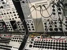 Earliest analog sequencers on Buchla 100 (array of knobs on the bottom)