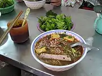 A bowl of bún ôc at a street food stall