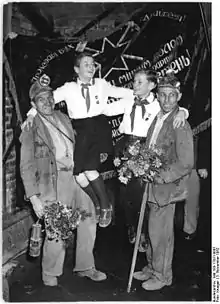 Miners and pioneers pose in front of the Banner of Krivoi Rog. 1952.