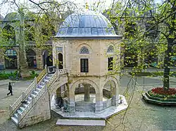 The courtyard of the Koza Han (1490-91) of Bursa, Turkey; the domed building is a small mosque (mescit)