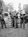 Delivery of 500,000 free cigarettes from the Overseas Tobacco League to the 5th Canadian Armoured Division, Groningen, Netherlands; (L-R): Captain J.F. Yeddeay, Lorne Scots; Senior Supervisor W.R. Blythman and Supervisor R.R. Jacks, both of Canadian Legion Auxiliary Services