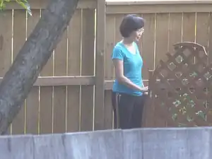 A candid photo of a woman in her yard.