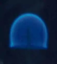 A candle in a microgravity environment. This is a rare example of a diffusion flame which does not produce much soot and does not therefore have a typical yellow flame