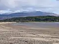 Carradale Beach with the snow-capped hills of the Isle of Arran in the distance.