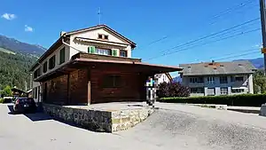 Two-story building with gabled roof next to railway line