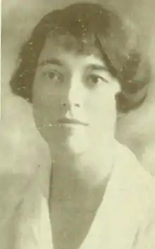 A young white woman with bobbed dark hair, wearing a white collared blouse.