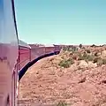 Central Bridges and track on the Central Australia Railway were very susceptible to wash-aways. Under-investment required the track to be laid on some river-beds. Here The Ghan is climbing out of the Finke River depression.