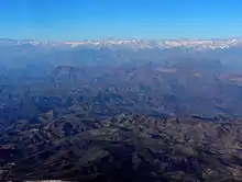 Wide view observatories from the air, including Cerro Pachón. In the distance are the Andes