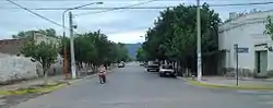 View southwest along Avenida Perón in downtown Chamical. The brushy Sierra de los Quinteros range can be seen in distant background