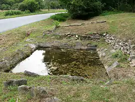 The abandoned washing pool, on the north side of the D15 road