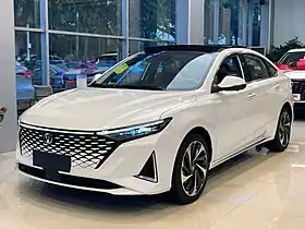 Front three-quarter view of a front-engined four-door car.