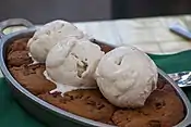 A cookie dessert, topped with ice cream.