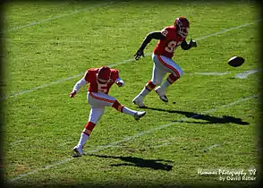 Connor Barth kicks off against New Orleans; Wallace Gilberry in background