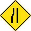 Road narrows ahead on left side