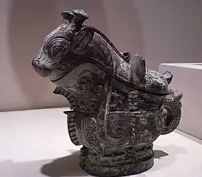 Ritual wine server (guang); 1100 BC; 21 × 22.9&nbsp;cm (8.25 × 9 in); Indianapolis Museum of Art (Indiana, U.S.). Adorning the surface of the vessel are three primary decorative animal motifs, including fifteen imaginary creatures cast in relief along the sides