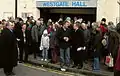 Users of Westgate Hall gather to object to the Council closure of the hall, 2010. Cllr Alex Perkins (left); Cllr James Flanagan (centre, holding papers)