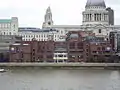 Baynard House and Faraday Building (green roof) on the left, City of London School centre on the north bank of the River Thames, London. Shows height of construction restriction.
