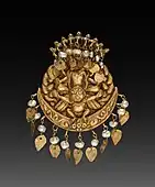 Earring with four-armed Vishnu riding Garuda with Nagas (serpent divinities); circa 1600; repousse gold with pearls; overall: 3.6&nbsp;cm; from Nepal; Cleveland Museum of Art