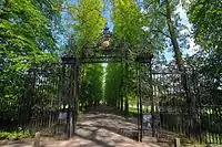 The Avenue of lime and cherry trees, and wrought iron gate to Queen's Road viewed from the Backs