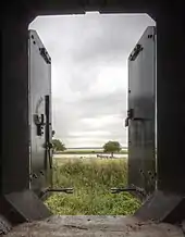 View from within a casemate showing the river, trees and grassy ground