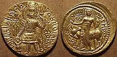 Coin of the Kushan king Kanishka II with, on the reverse, a depiction of Oesho and the word "Oesho" in modified Greek script.