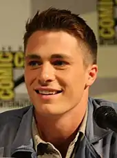 Crew cut: top, long; back/sides, semi-short taper; sideburns, short; short pomp (pompadour) front, arched; mid top, rounded; crown, rounded; front hairline, average; wavy hair.