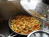 Cooking jasha maru, a traditional dish consisting of minced chicken, tomatoes, and other ingredients