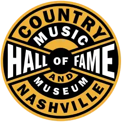 The logo of the Country Music Hall of Fame and Museum. It is features black and yellow stripes with a circular design.