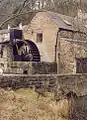 A mid-nineteenth century water wheel for a mill grinding locally mined barytes . It is no longer used for any purpose but can be seen turning on occasion.