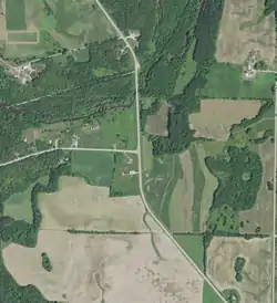 Ryans Corner on August 7, 2020. County Trunk Highway A (left) and County Trunk Highway C make a T-intersection. The Kewaunee River is visible to the north of Ryans Corner, and the Ahnapee State Trail is visible to the north of the river.