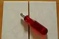 Simple glass cutter used to cut ceramic tile.
