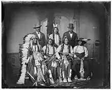 (standing) Joe Merrivale, Young Spotted Tail, Antoine Janis. Seated: Touch the Clouds, Little Big Man, Black Cool, unknown