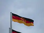 National flag of the German Democratic Republic flying.