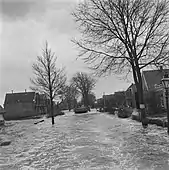 DUKW traversing a submerged village street.