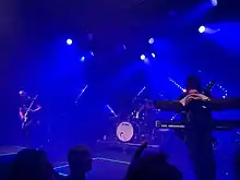 Dance with the Dead performing in Helsinki, Finland, in October 2022 during the Driven to Madness tour (from left: Tony Kim, tour drummer John Terry, and Justin Pointer)