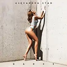 The cover sees Stan posing provocative in front of a beige backdrop