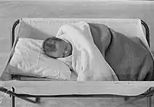 An infant sleeping in 1940. The use of pillows and blankets are no longer recommended as these can inadvertently cause suffocation.