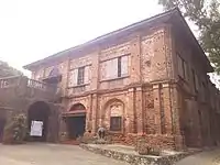The Northern Luzon variant's most common feature is the use of brick up to the second floor facade, in contrast with the common wooden second floor facade in other provinces. This particular building is the convent of Sarrat Church in Ilocos Norte