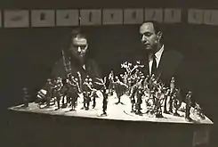 An 80-figure sculpture in bronze depicting Dante's Divine Comedy exhibited at the Royal Palace in Milan for the 700th anniversary of Dante's birth. Purchased by the Canadian government as a travelling exhibit of exemplary Canadian Art.