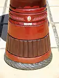 Cowrie shell and tire decoration on the foot of a djembe