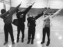 A group of teens dabbing, a popular fad and gesture of the youth around 2015–2016. Dabbing was the most prominent dance trend of the 2010s, which joined such dances as Flossing and the Harlem Shake.